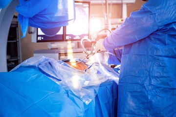 Surgeons perform spinal surgery in an operating room with a visualization system